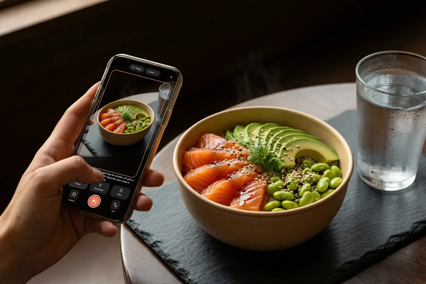 A hand with a phone snaps a salmon bowl, with the GramSense scanner on screen
